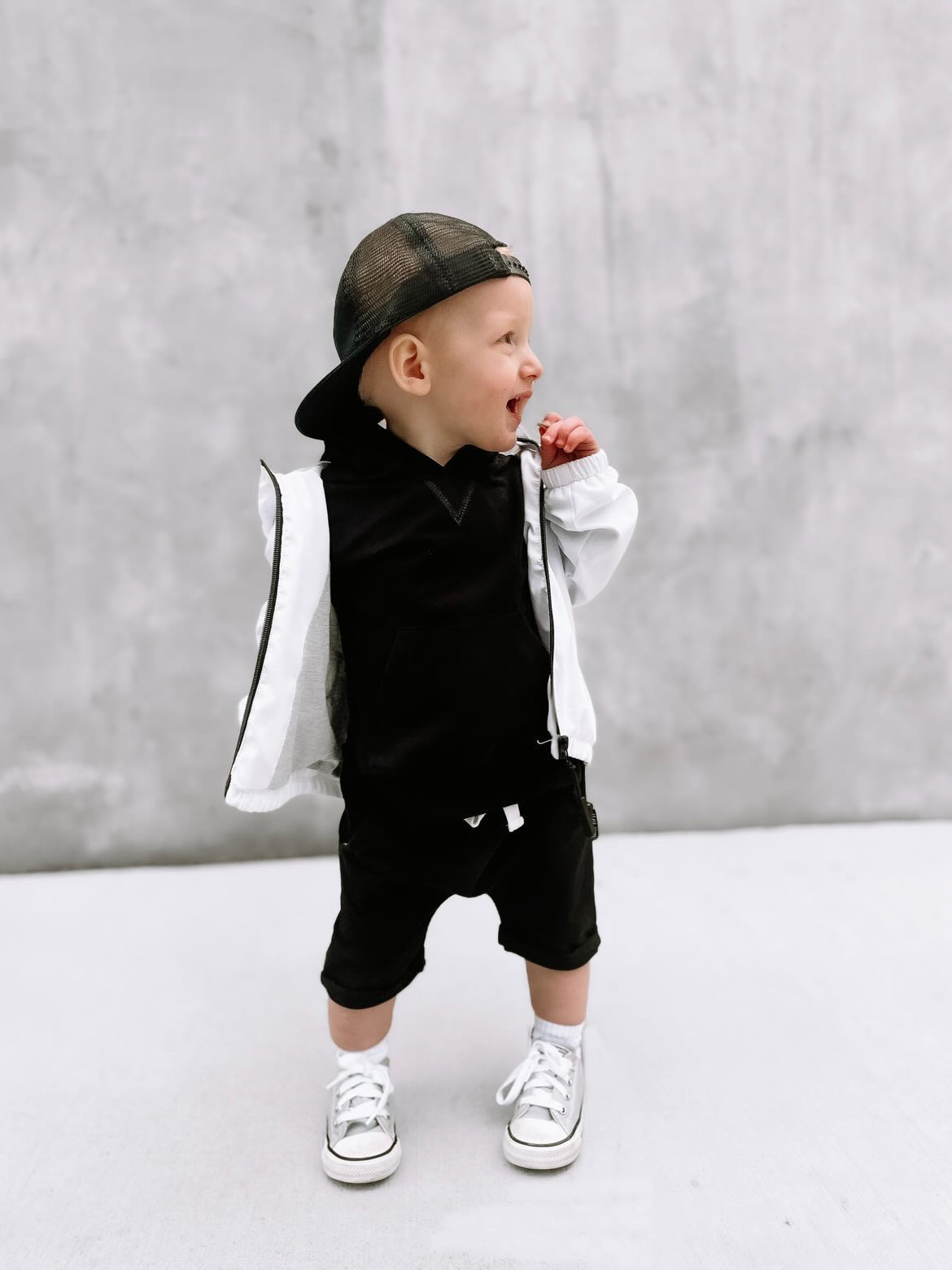 Toddler in toddler trendy outfit with black toddler harem shorts