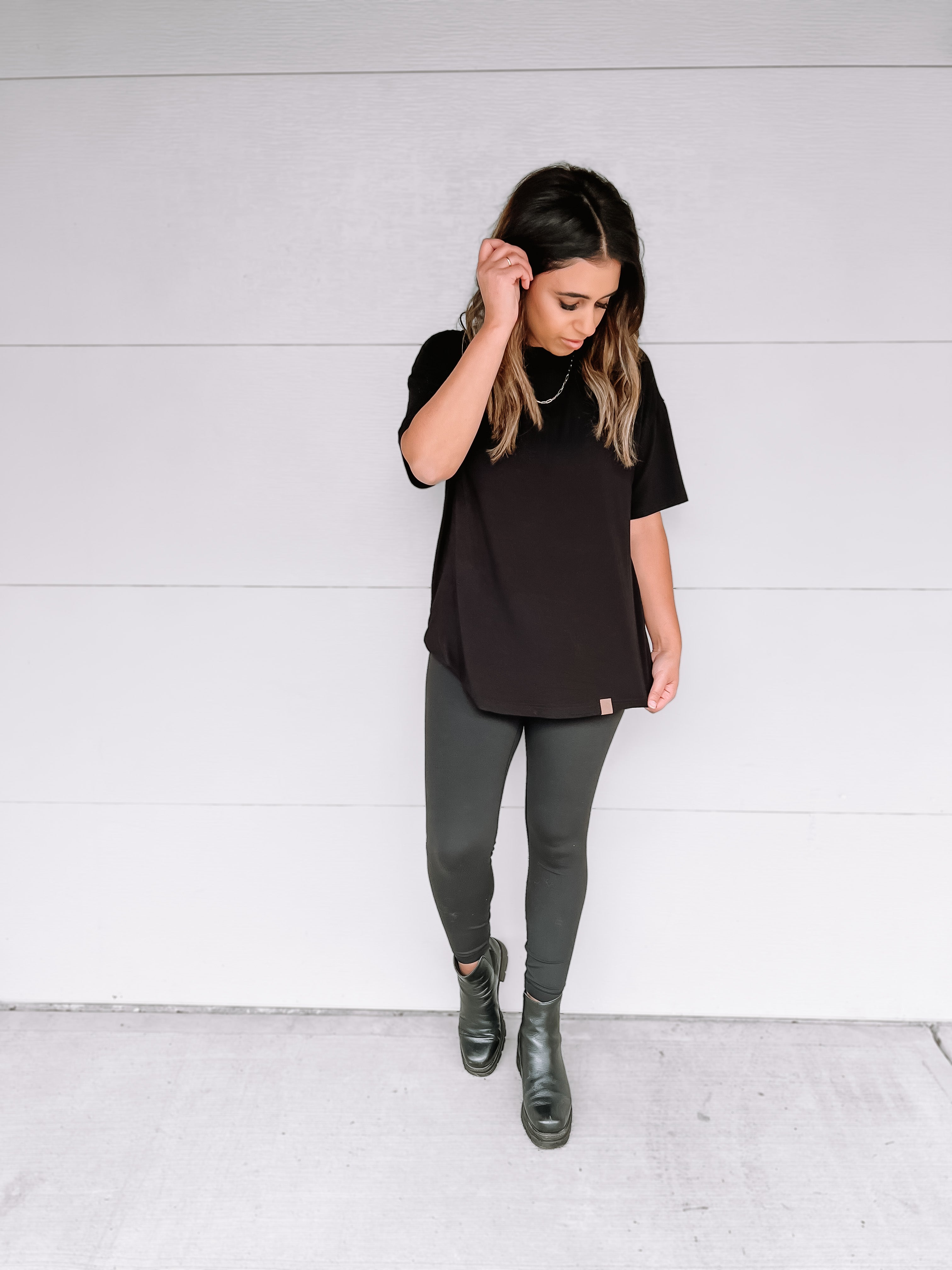 Woman in black oversized bamboo tee.