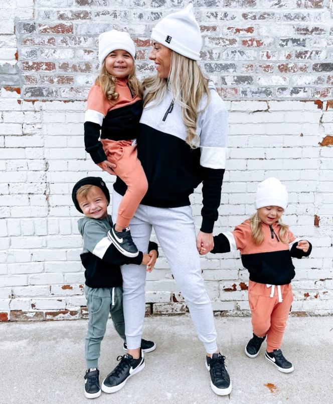 Woman in light grey joggers. Kid's matching in color block sweatpants and quarterzips