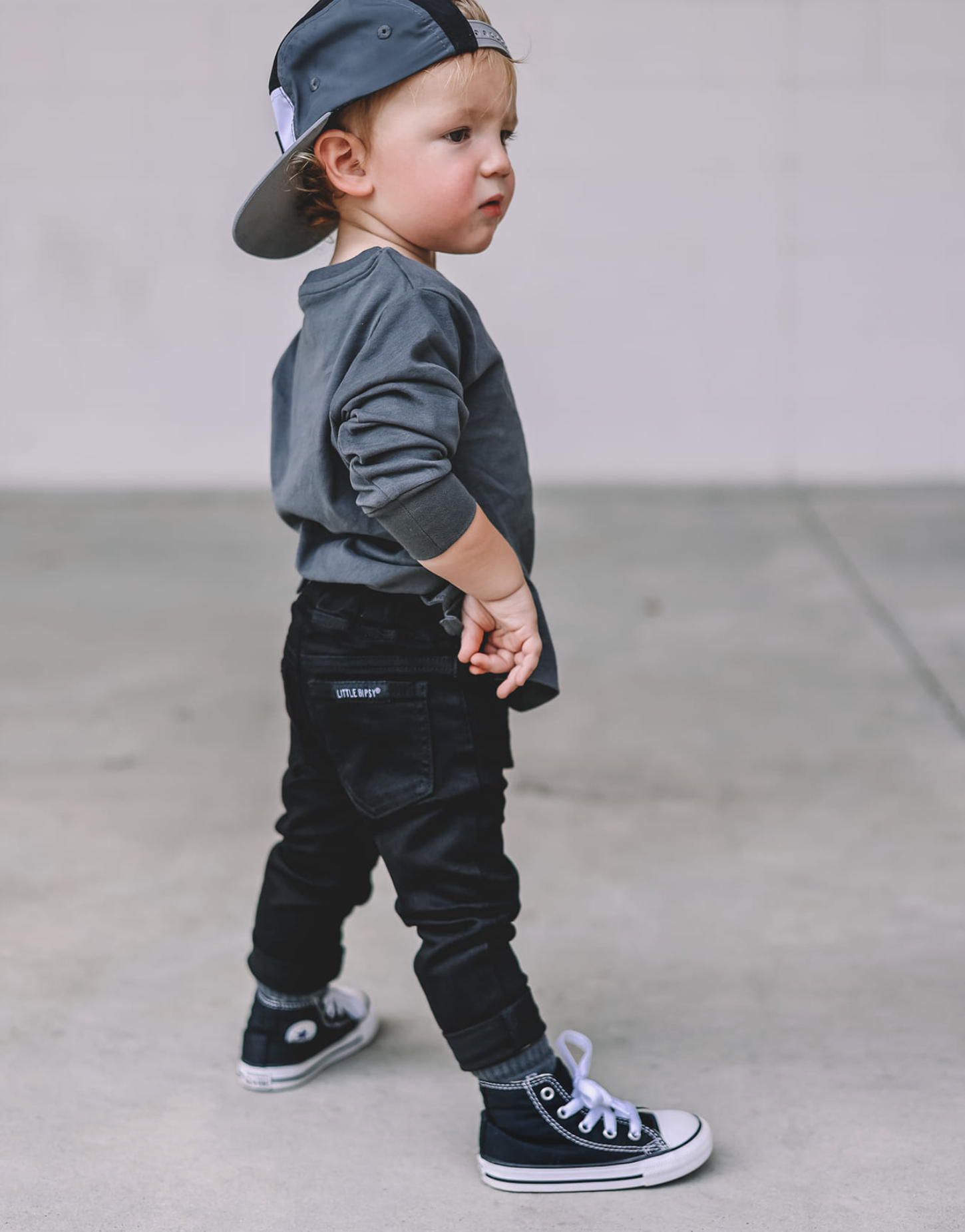 Toddler in kids trendy outfit. kids black denim. brand: Little Bipsy