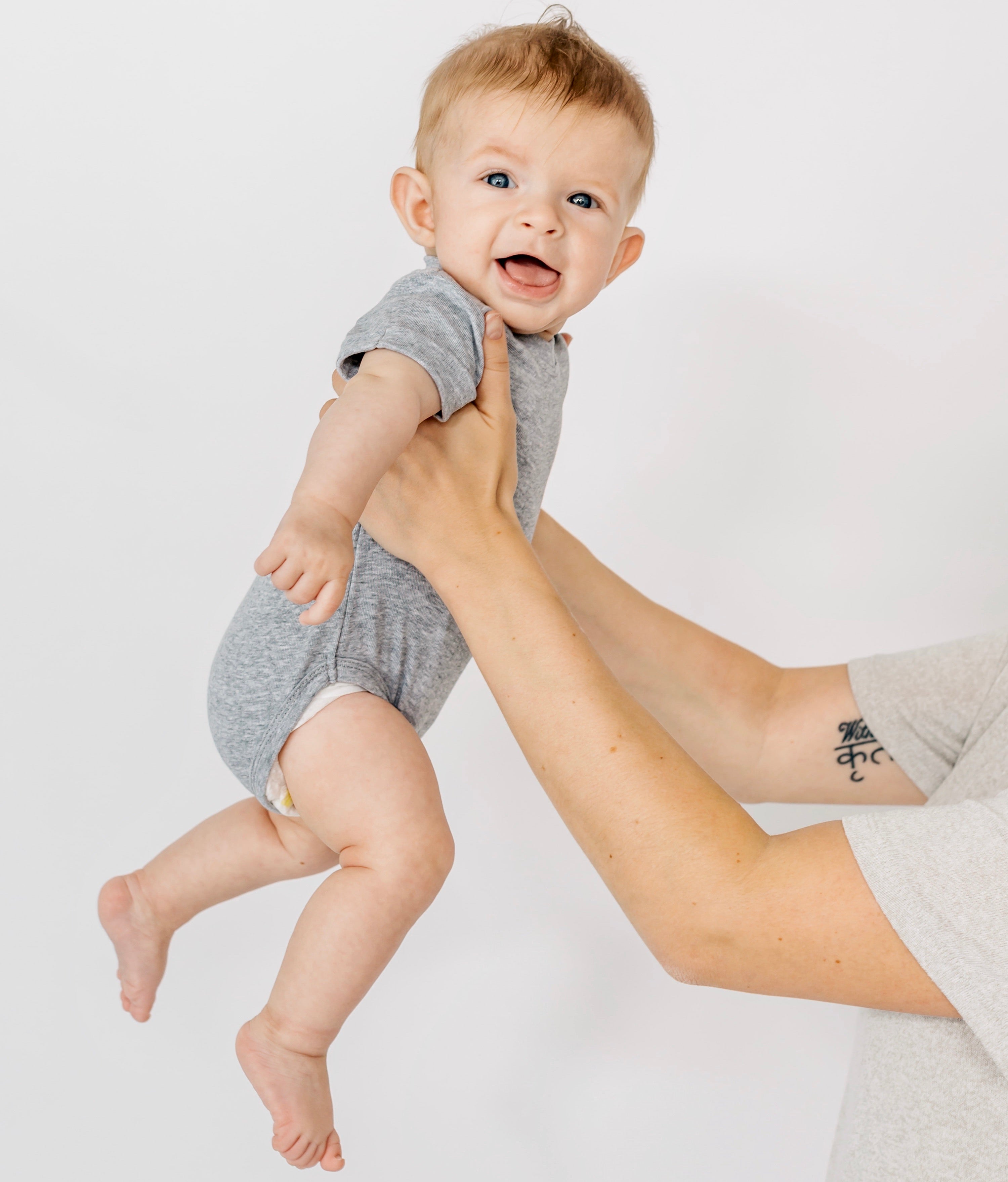 Baby in basic onesie in grey