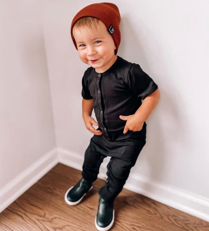 Toddler in black button up onesie